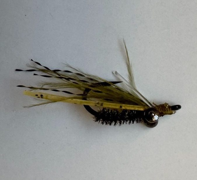 Close-up of olive crazy charlie fly for inshore fly fishing in Grand Cayman, Cayman Islands - the best fly for permit