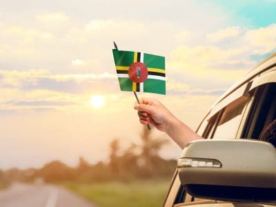 Waving,The,Dominica,Flag,Against,The,Sunrise,Or,Sunset,From